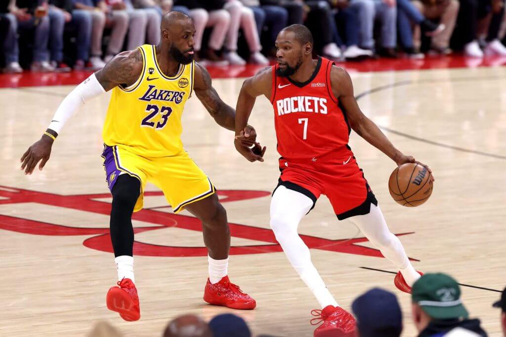 LeBron James and Alperen Sengun battling for position during the 2026 Rockets vs Lakers playoff game at Crypto.com Arena.