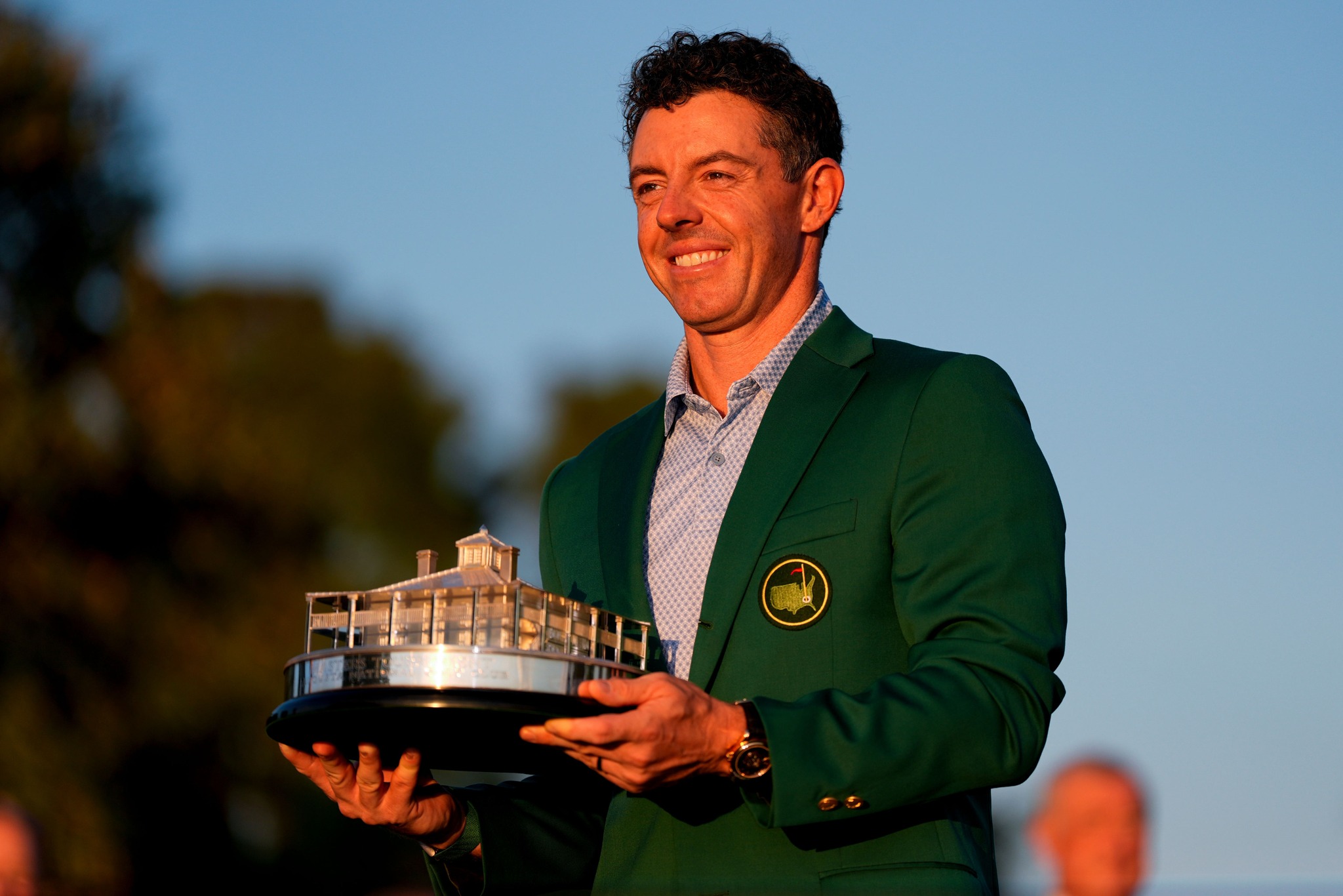 Rory McIlroy smiling and wearing the iconic Green Jacket after winning the 2026 Masters Tournament.