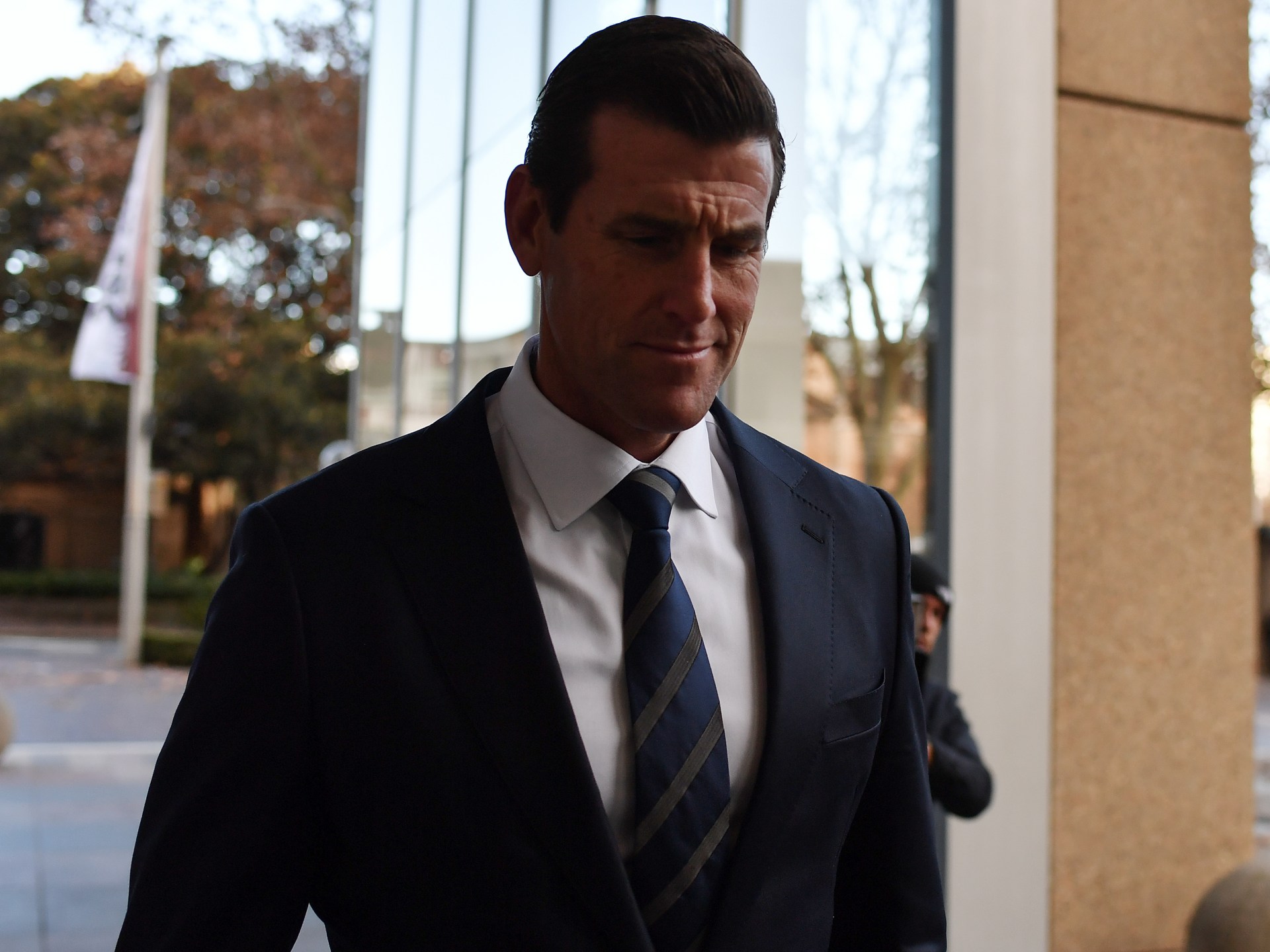 Ben Roberts-Smith, a former Australian soldier, departing court amidst war crimes allegations.