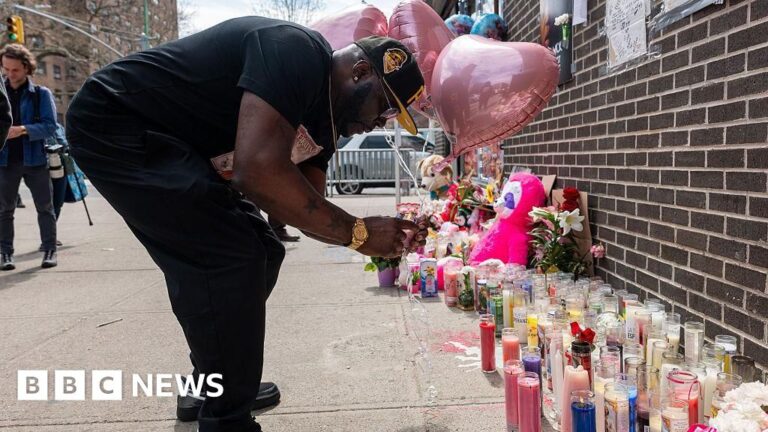A solemn memorial of balloons and flowers for a baby killed in a shooting in Brooklyn, New York City.