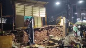 Bengaluru storm aftermath: collapsed wall near Bowring Hospital, flooded roads, uprooted trees, and damaged offices.