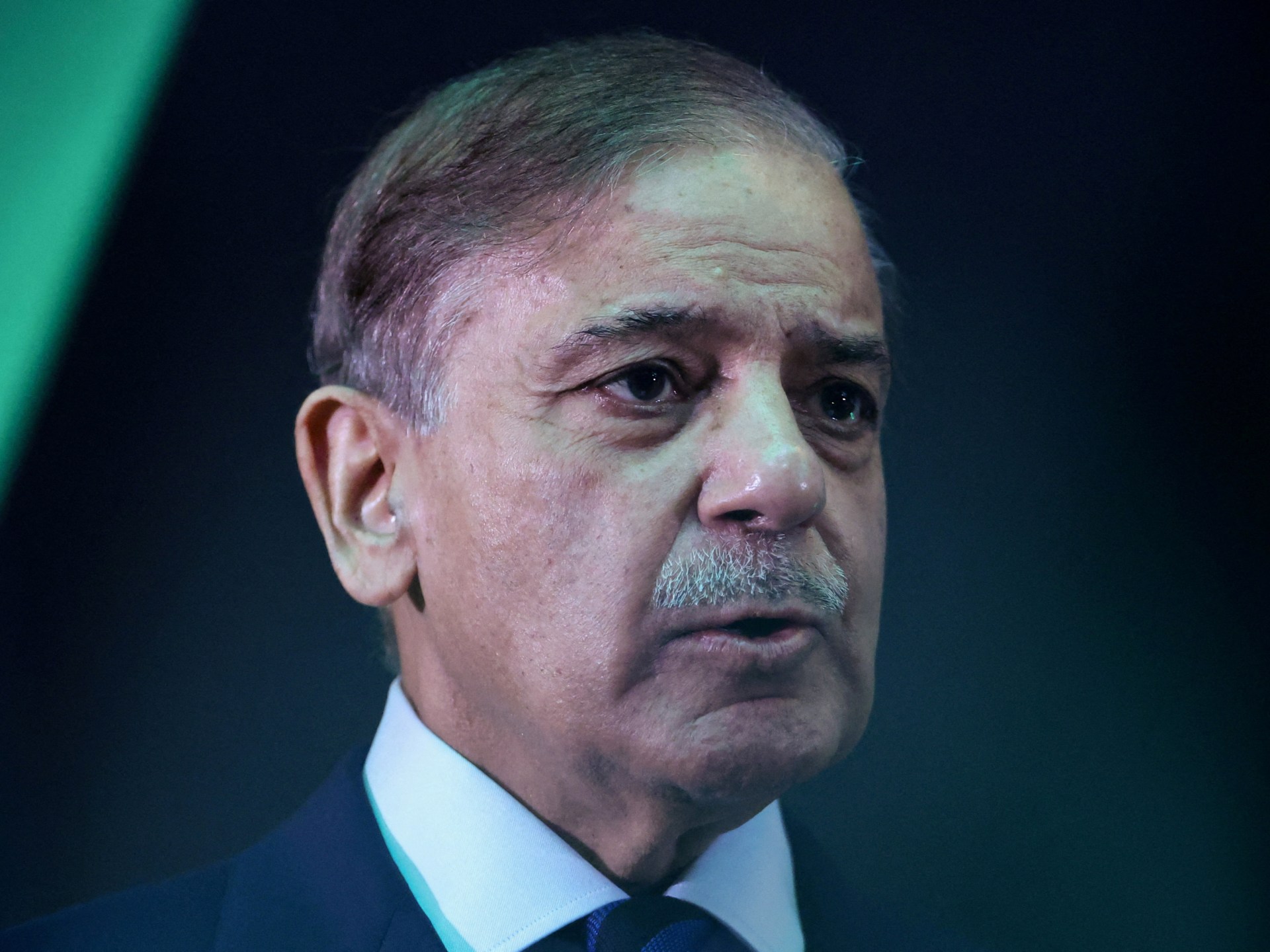 Pakistani Prime Minister Shehbaz Sharif looks on during a conference, mediating Middle East tensions.