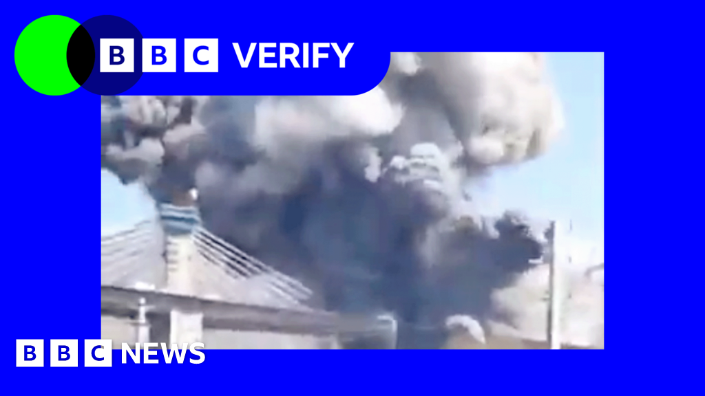 Smoke rises from a damaged bridge in Iran after a military strike.