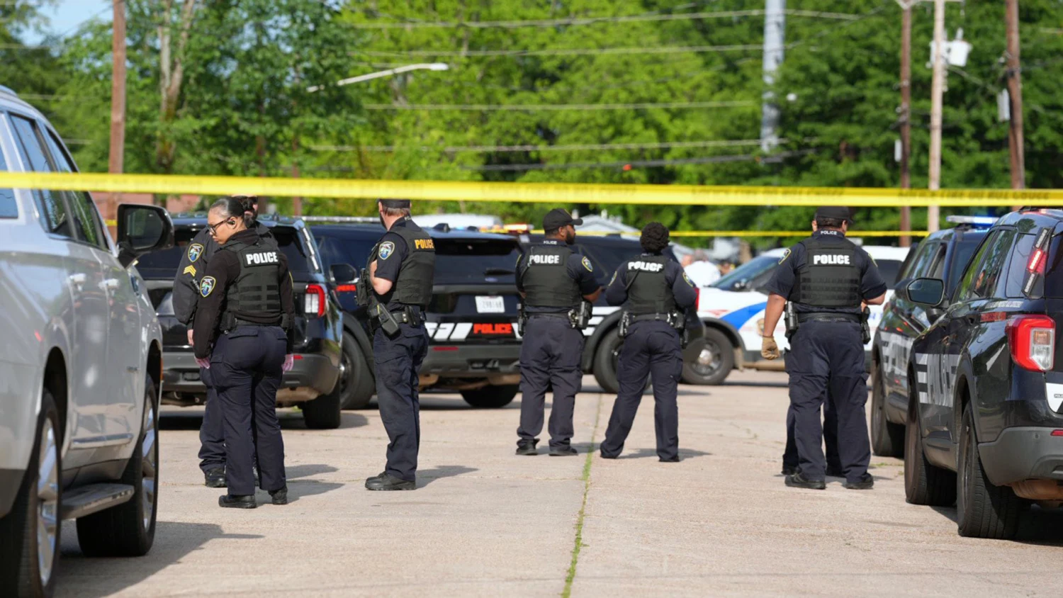 Police vehicles and crime scene tape blocking off a residential street in Shreveport, Louisiana following the tragic 2026 shooting.