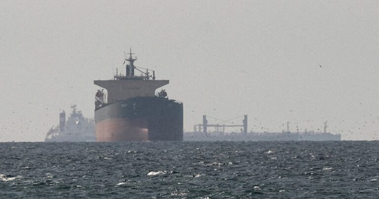 Cargo ships in the Gulf near the Strait of Hormuz, symbolizing maritime trade and geopolitical tensions.