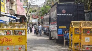 Image of Delhi Police personnel, representing a law enforcement operation.