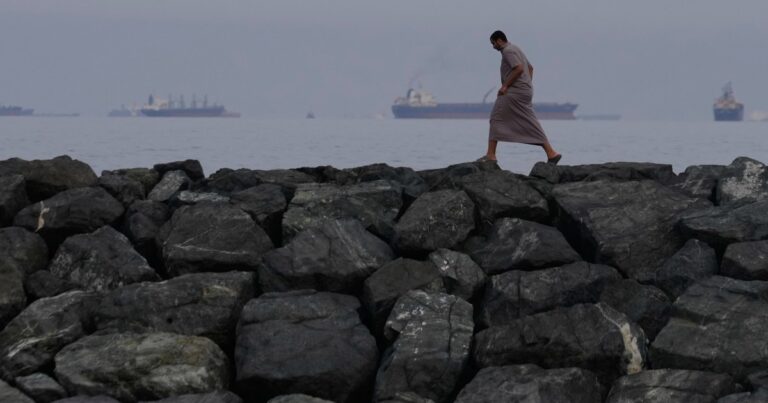 Oil tankers in the Strait of Hormuz, symbolizing the strategic importance of the waterway in the challenge to US dollar hegemony.
