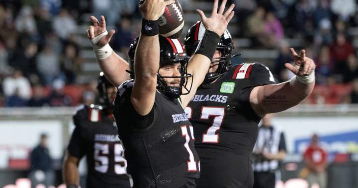 Ottawa Redblacks quarterback Bryson Barnes celebrates a touchdown against the Montreal Alouettes during a CFL pre-season game.