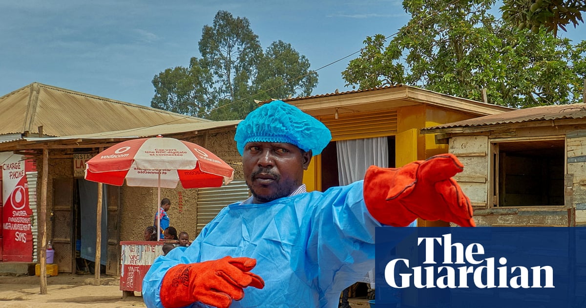 Medical worker directing traffic at an Ebola screening checkpoint in DR Congo