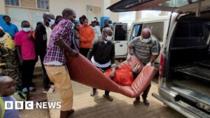 A man is carried from an ambulance to a hospital in Bunia, DR Congo, following an Ebola outbreak confirmation. A health worker in full protective gear enters an Ebola treatment centre in Beni.