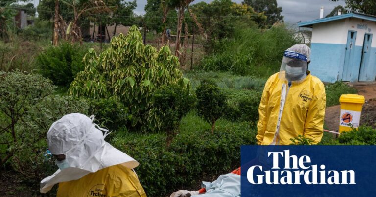 Medical staff in PPE carry an Ebola patient on a stretcher through hospital grounds in Congo.