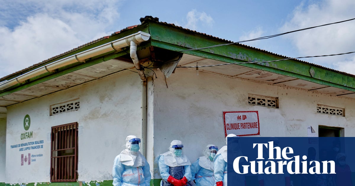 Red Cross workers in protective gear disinfect a hospital in Rwampara, Ituri province, DRC, for Ebola.