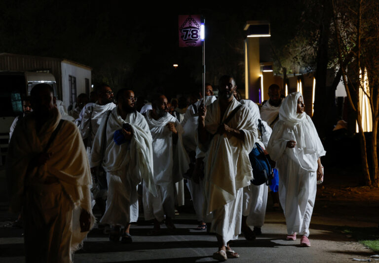 Hajj pilgrims arrive in Mina near Mecca for Arafah Day, a spiritual journey.