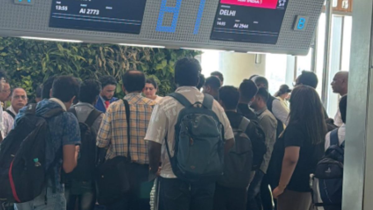 Passengers wait amidst chaos during a Mumbai Airport strike affecting Air India flights.