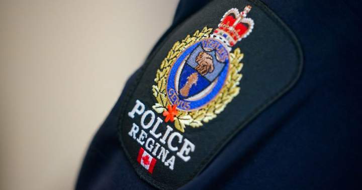Image of Regina police vehicle with text overlay describing an officer being charged.