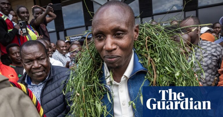 Sabastian Sawe wearing a green garland, embraced by friends and family at Eldoret airport after his record-breaking marathon.