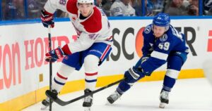 Image of Montreal Canadiens defenceman Lane Hutson controlling the puck during a 2026 Stanley Cup playoff game against the Tampa Bay Lightning.