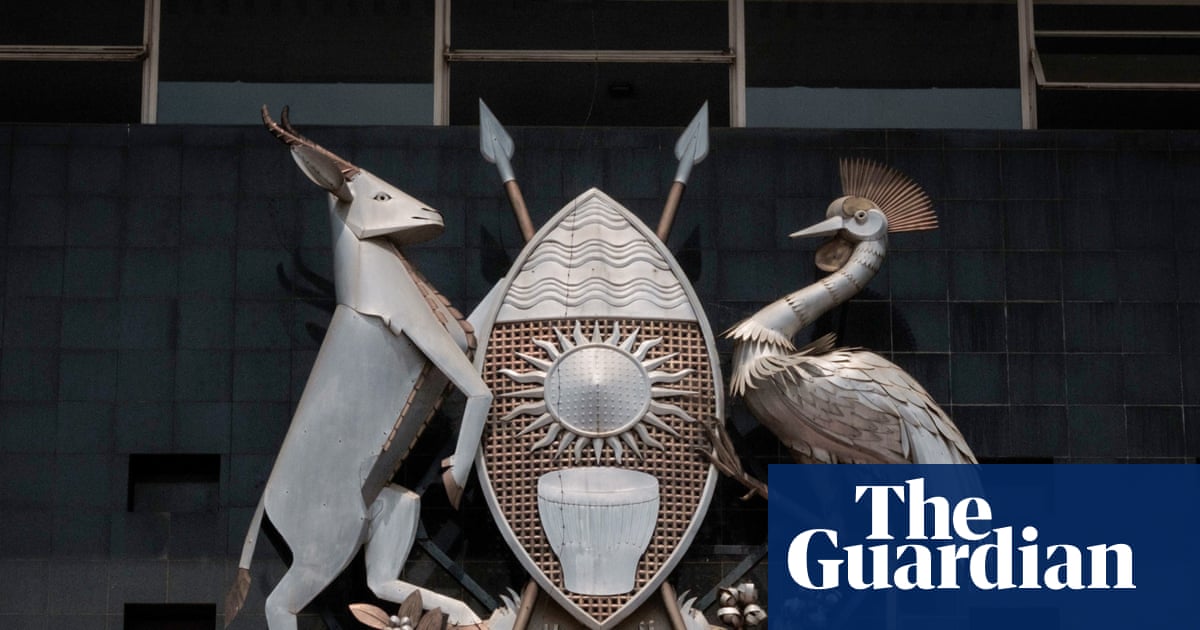 Uganda's coat of arms on parliament building, symbolic of national identity, amid debate over new sovereignty bill.