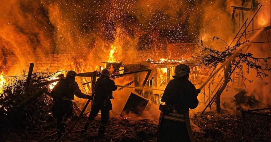 Ukrainian rescue workers extinguishing a fire in a residential building destroyed by a Russian drone strike in Odesa, Ukraine.