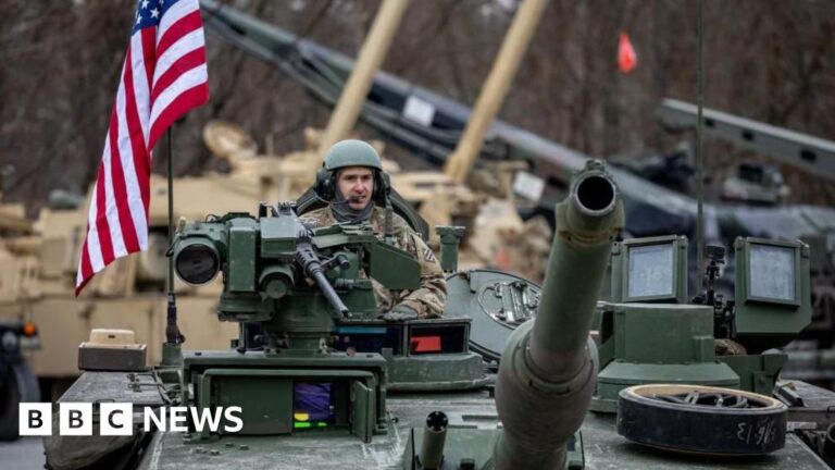 US soldiers on a tank in Germany, symbolic of the US military presence in Europe.