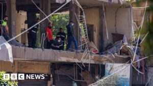 Image of emergency services at the site of an Israeli strike in Beirut's Dahieh suburb.