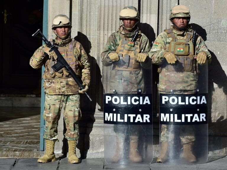 Military Police stand guard outside the presidential palace in La Paz after Bolivia declares a state of emergency due to widespread blockades.