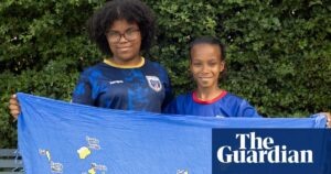 Two young people, Lauryn and Joylen, proudly hold up the Cape Verde flag.