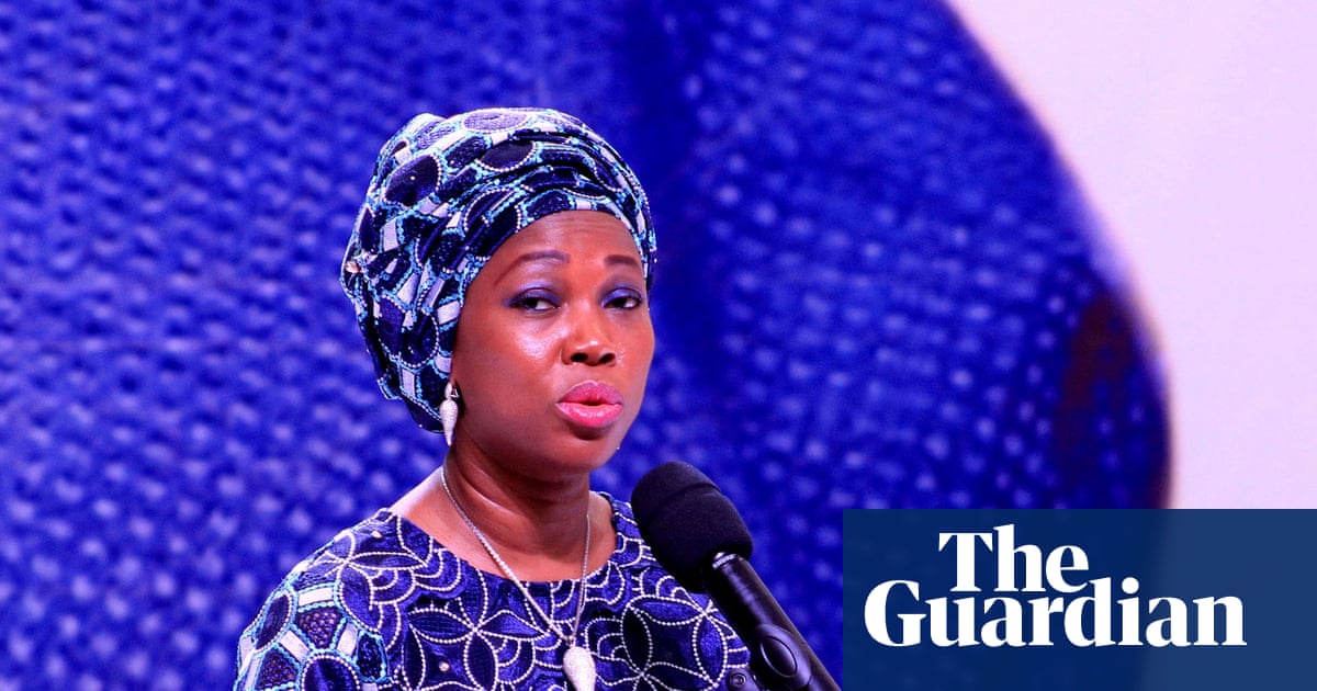 Fatima Jabbe-Bio speaking at a podium with a microphone