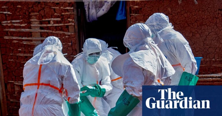 People in hazmat suits retrieve a body of an Ebola victim in DRC.