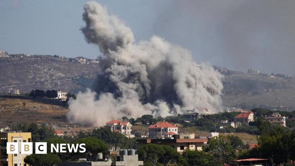 Aerial view of southern Lebanon after Israeli strikes, showing smoke rising from damaged buildings.