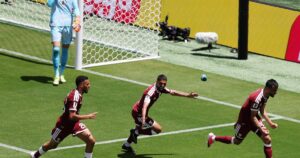Boualem Khoukhi celebrates with teammates after scoring Qatar's equalizer against Switzerland in the World Cup 2026 Group B match.