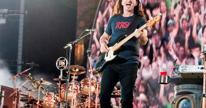 Geddy Lee and Alex Lifeson performing live with Anika Nilles on drums during the Fifty Something tour.