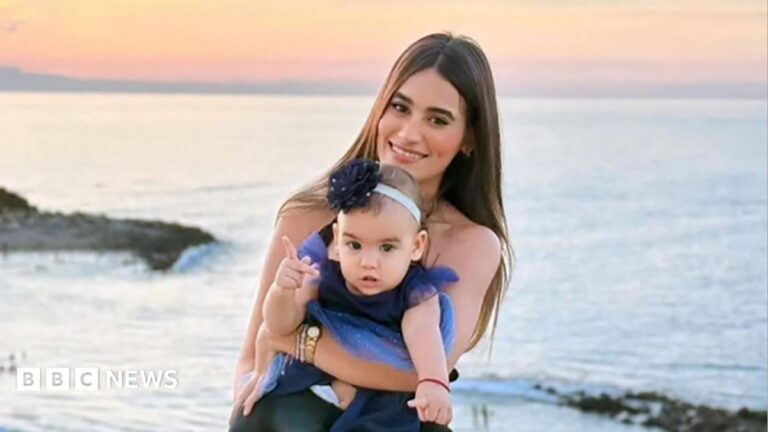 Image of a mother and daughter on a beach at sunset, symbolizing a mother's protective love.