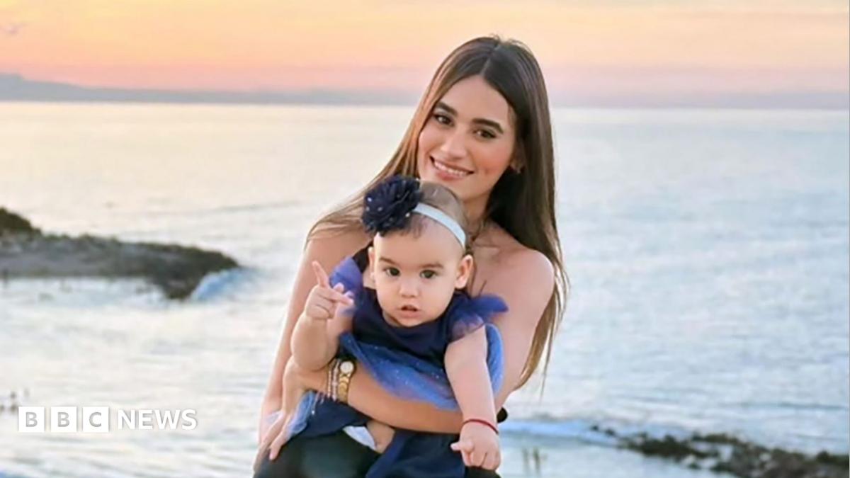 Image of a mother and daughter on a beach at sunset, symbolizing a mother's protective love.