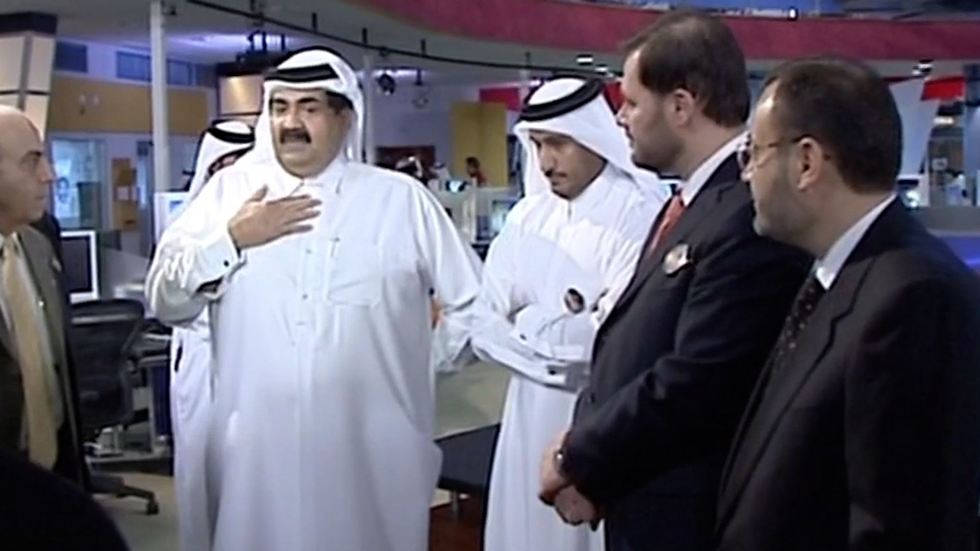 Image of Sheikh Hamad, Al Jazeera's founder, with news background