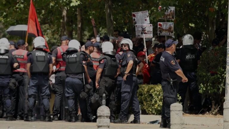 Albanian protesters throwing eggs at lawmakers' cars outside parliament