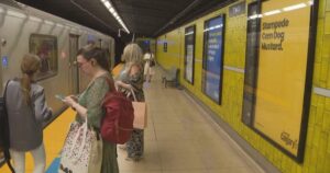 Toronto subway station transformed by Calgary tourism campaign featuring vibrant colours and local references.