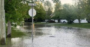 Aerial view of submerged cars and homes during a severe flood in Canada.