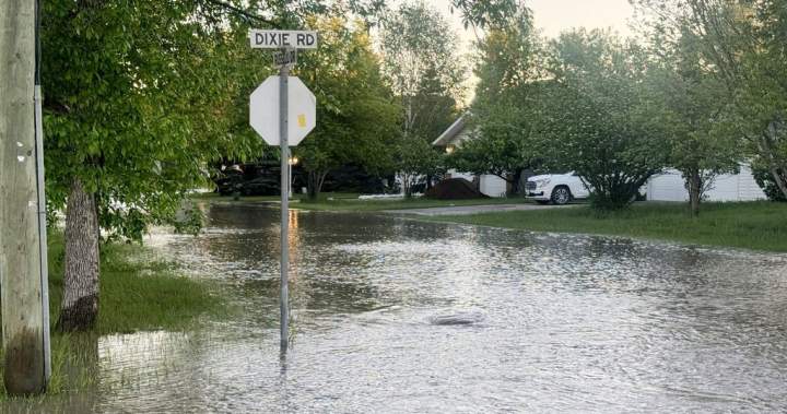 Aerial view of submerged cars and homes during a severe flood in Canada.