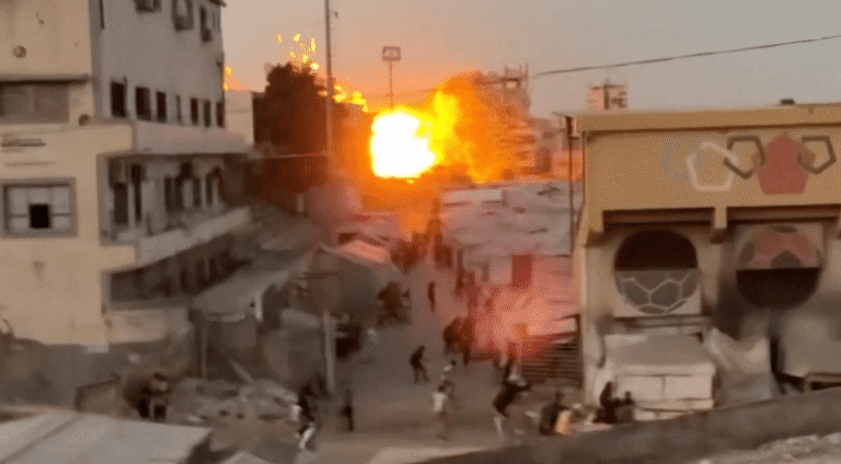 Video still showing aftermath of an airstrike near a displacement camp in Gaza City.