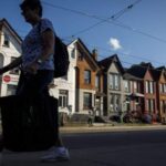 Image depicting the financial stress faced by Canadians turning to HELOC debt, with a focus on potential risks.