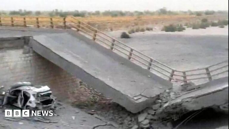 Image of a damaged bridge in Iran after a US airstrike, showing rubble and broken concrete.