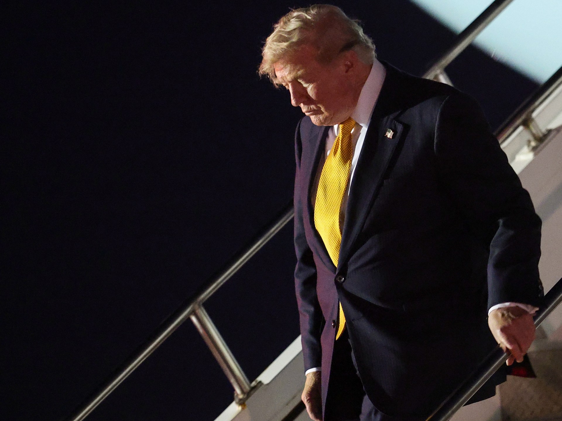 US President Donald Trump disembarking Air Force One after a summit, amidst reports of renewed Iran negotiations.