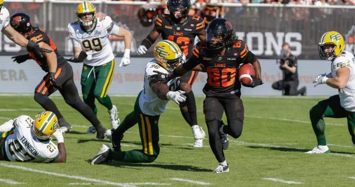 James Butler running with the football for the B.C. Lions during CFL action against the Edmonton Elks.