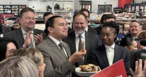 Manitoba Premier Wab Kinew in a grocery store promoting the provincial sales tax cut on food.