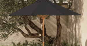 A vibrant yellow patio umbrella providing generous shade over an outdoor seating area.