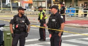 Image of police activity or a memorial at the site of the Toronto festival shooting.