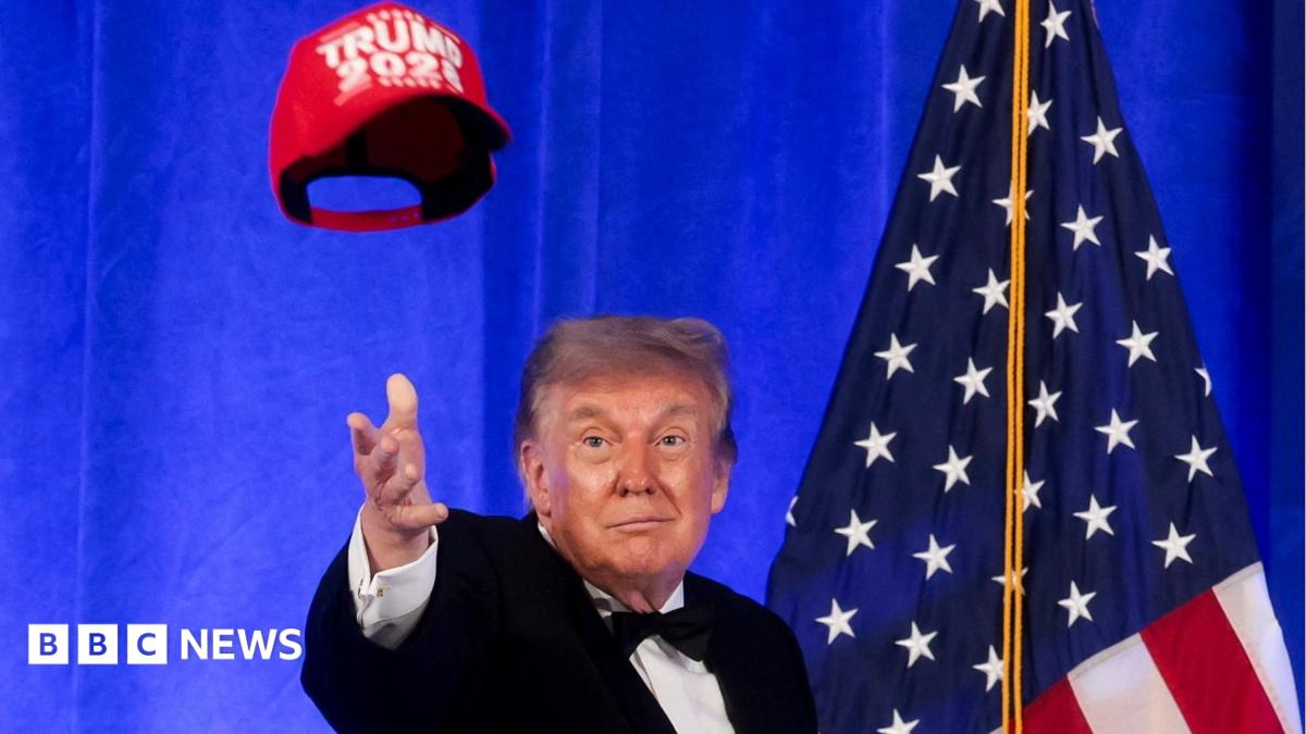 President Trump addressing reporters at the White House Correspondents' Dinner with a mischievous expression.