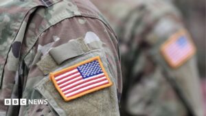 USA patch flag on a US military uniform, symbolizing military presence.