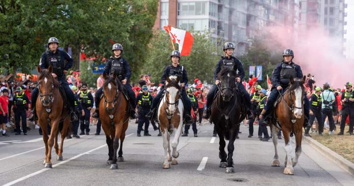 Vancouver police officers on horseback patrol during FIFA World Cup.